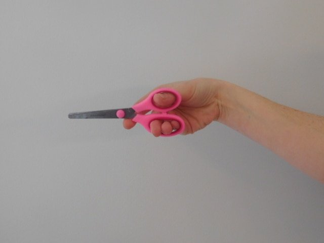 Want to know how to teach a child to hold scissors? Use the friendly shark method! Kids love this little trick to help them hold scissors.