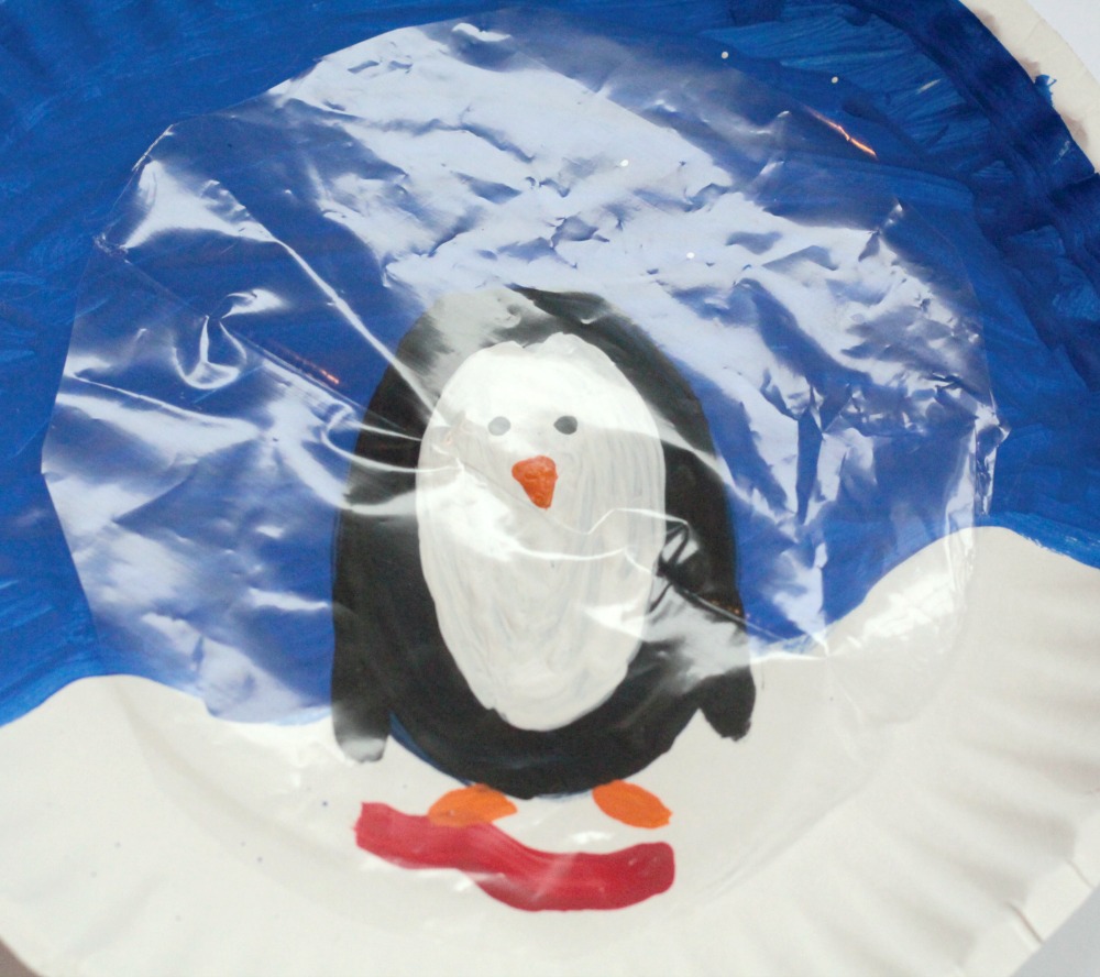 Instead of playing with dangerous and messy snow globes, kids can make their own paper plate penguin snow globe using a paper plate and some craft supplies!