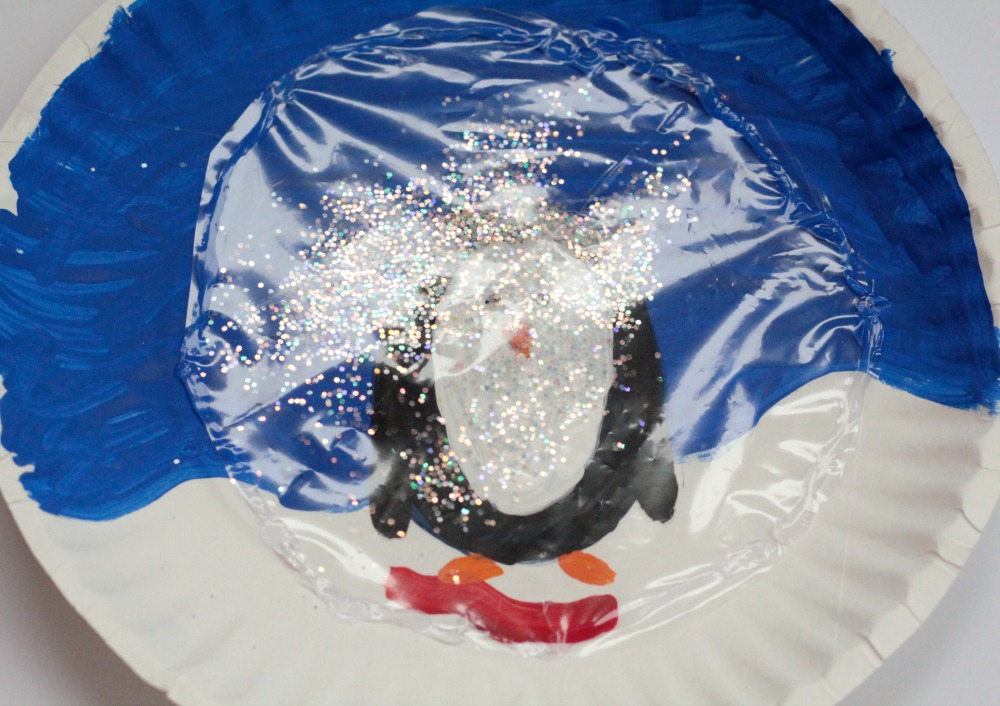 Instead of playing with dangerous and messy snow globes, kids can make their own paper plate penguin snow globe using a paper plate and some craft supplies!